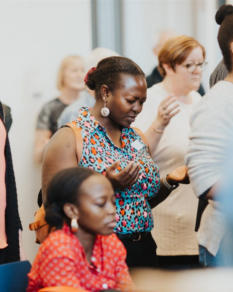 At a Divine Renovation event for parish renewal, a woman is deep in prayer.